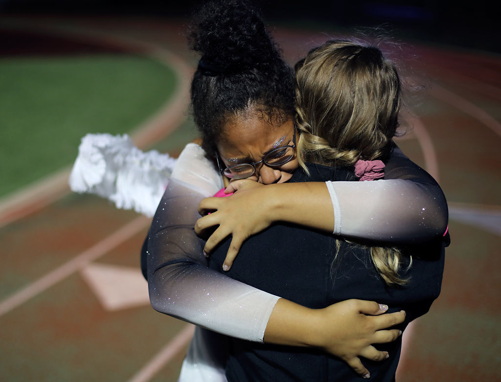 Rock Bridge High School seniors Amanda Andrews and Hannah Evans embrace